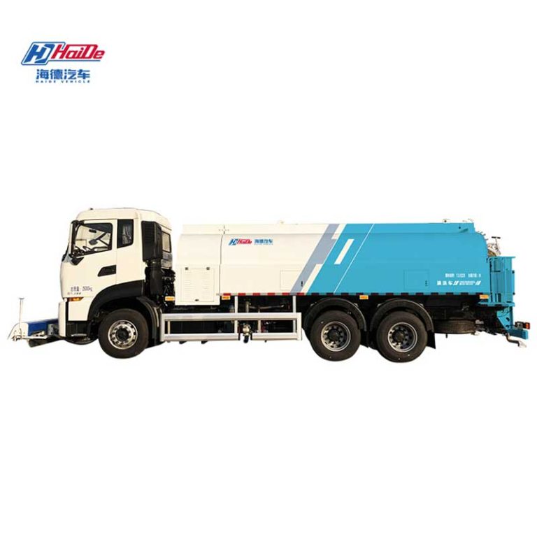Road cleaning truck rinsing municipal pavement during street maintenance